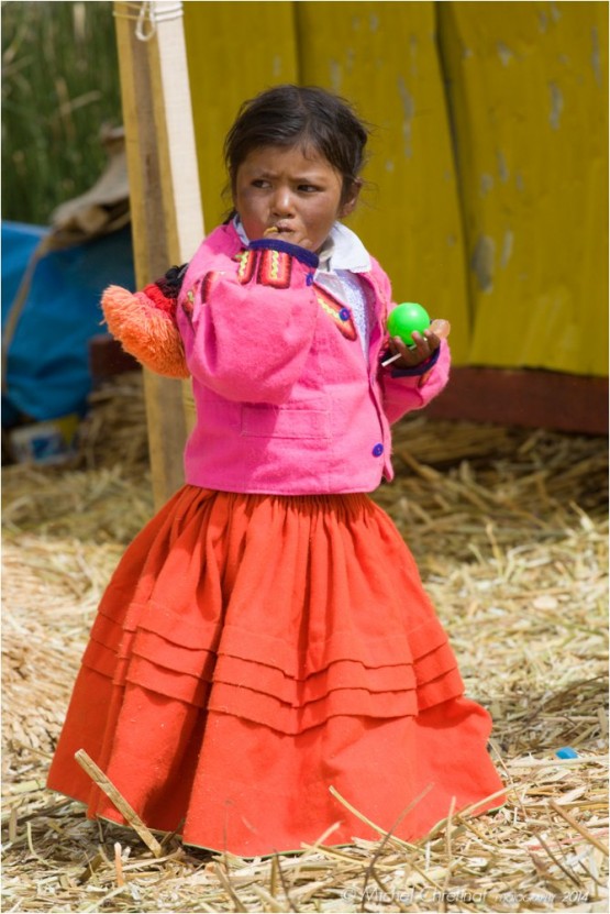 Aymara young girl on Uros floating Island of the Titicaca lake